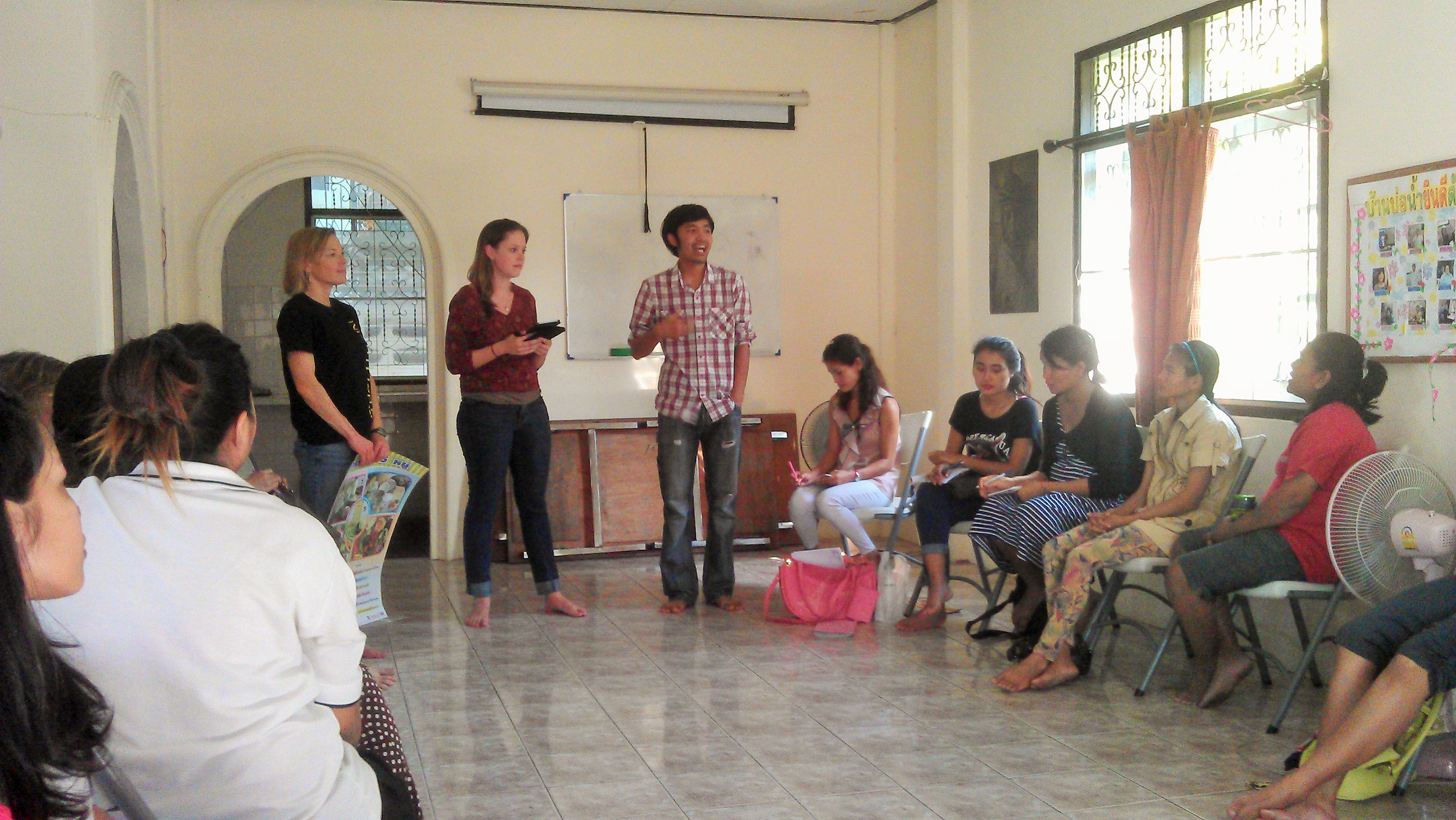 teaching about health to a group of 20+ staff and women