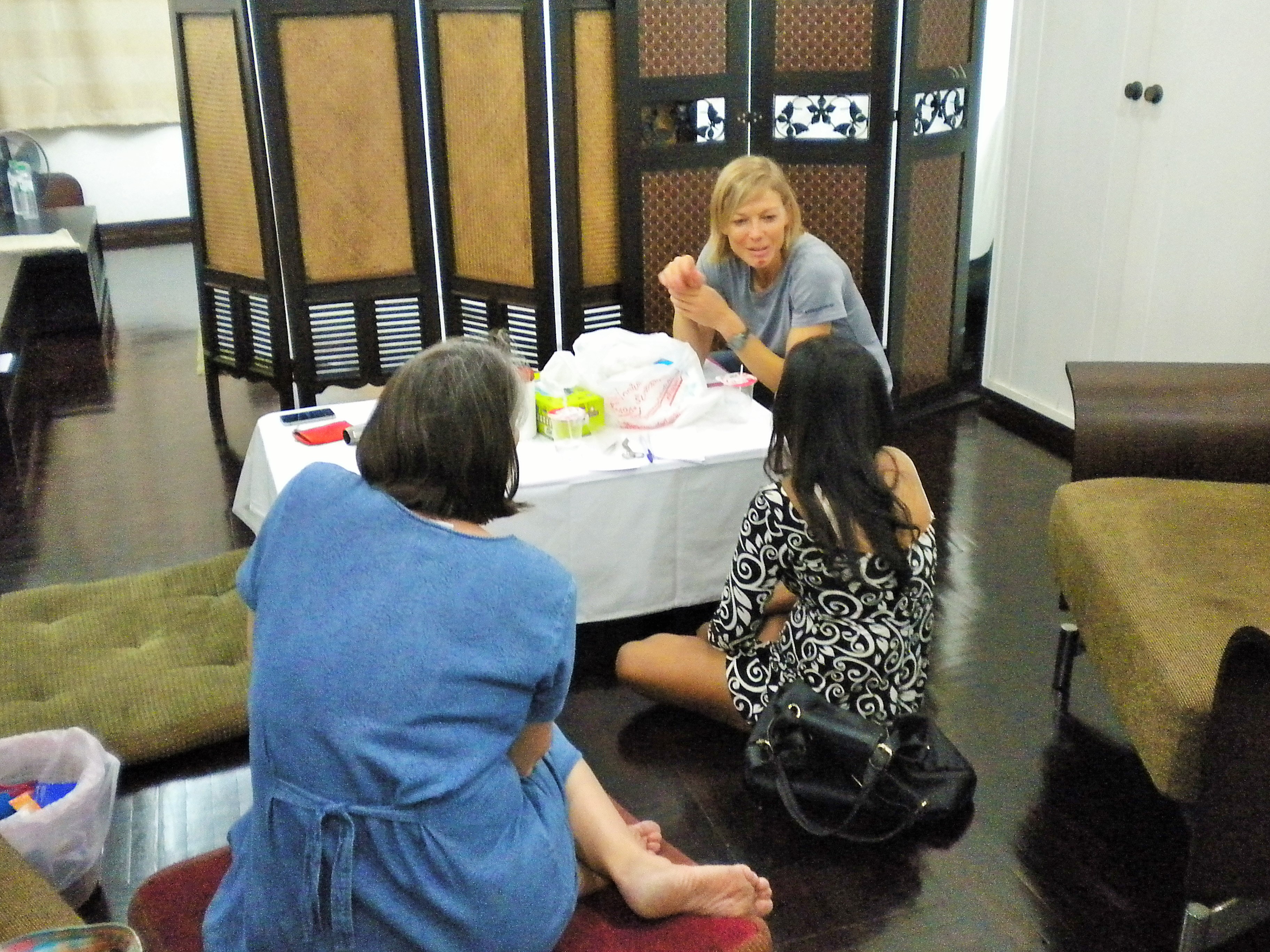 Explaining the proper use of the medications with a woman who works the streets in Bangkok. 